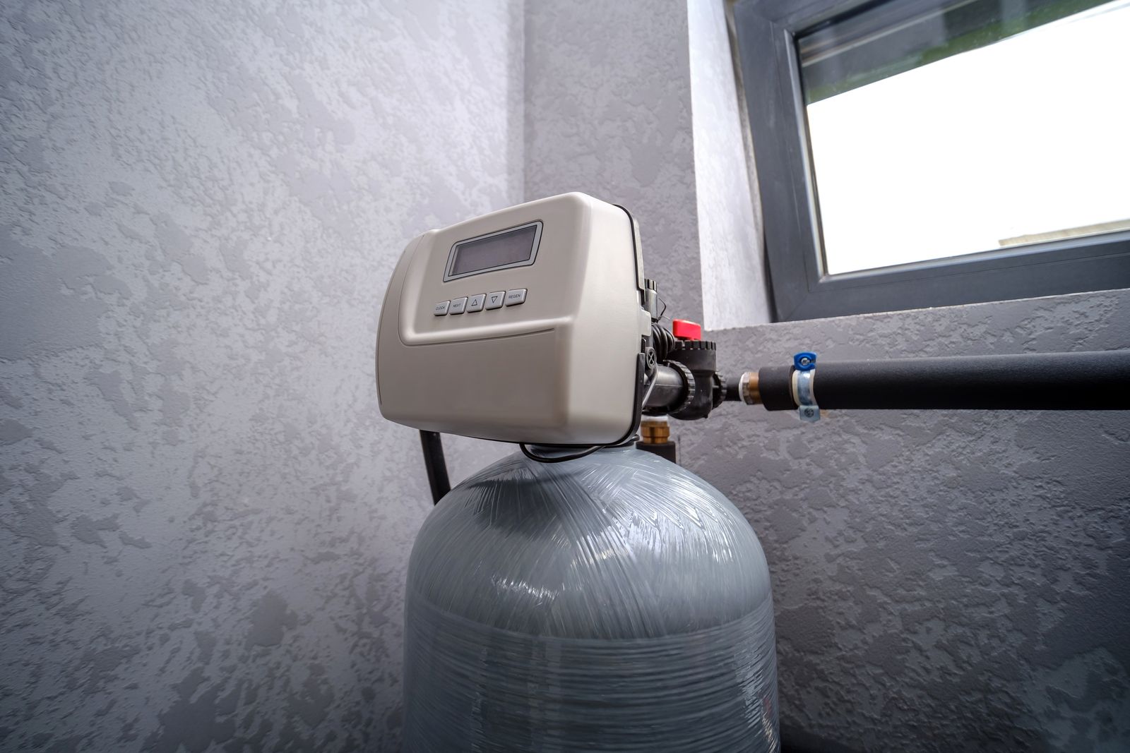 Water softener system installed in a home utility area